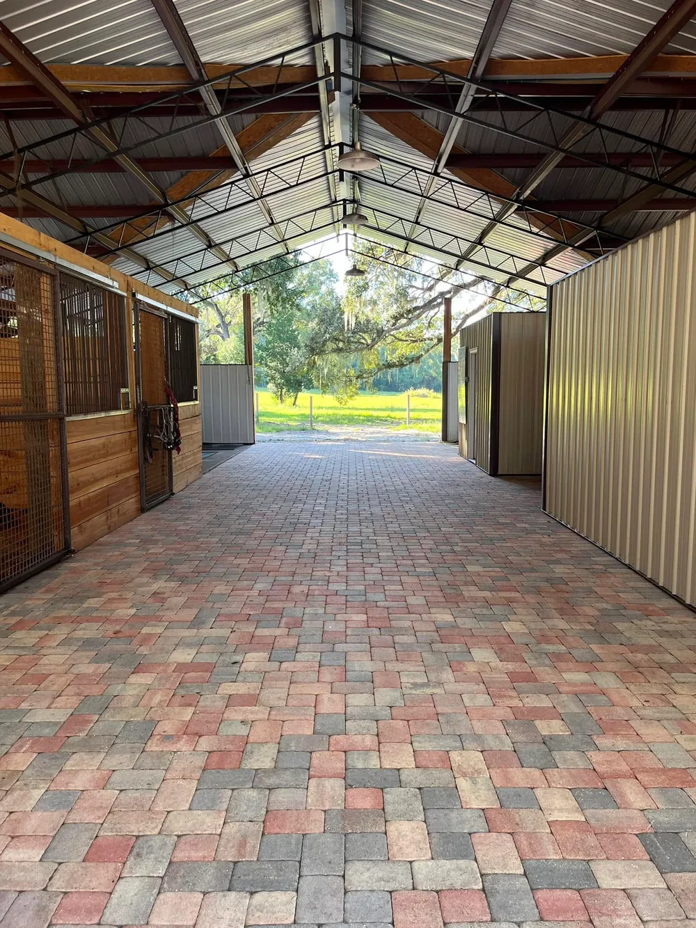 Finished tumbled paver aisle running between horse stalls