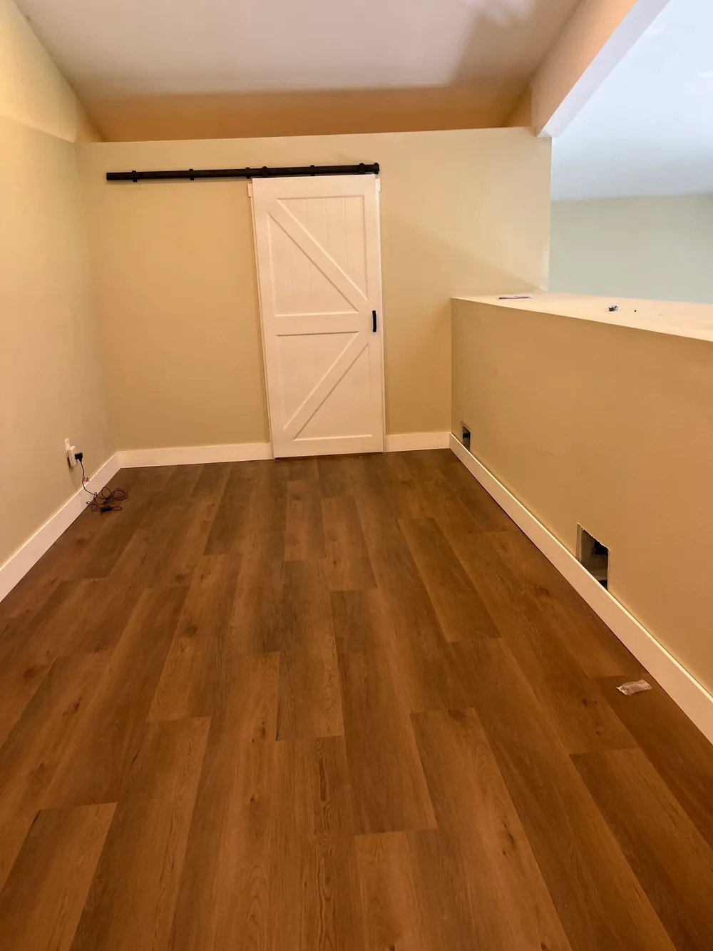 Finished loft room with a sliding barn door