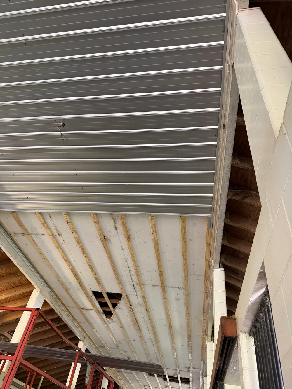 New metal ceiling liner over a horse barn aisle