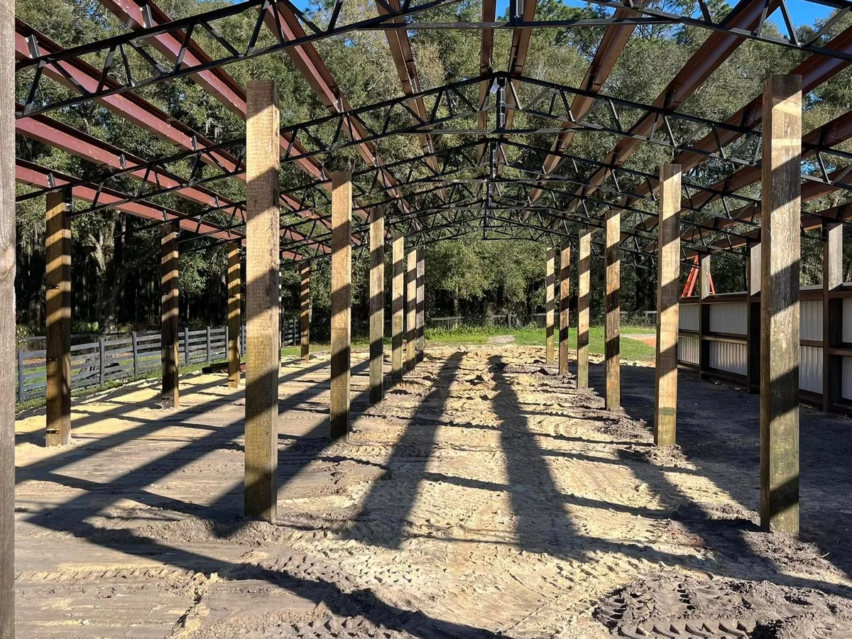 Steel trusses and red iron purlins set on posts