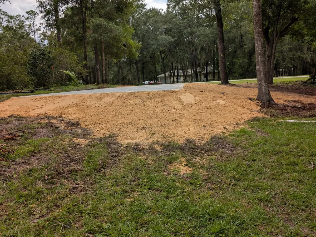 Graded sand dressed around a newly poured concrete pad